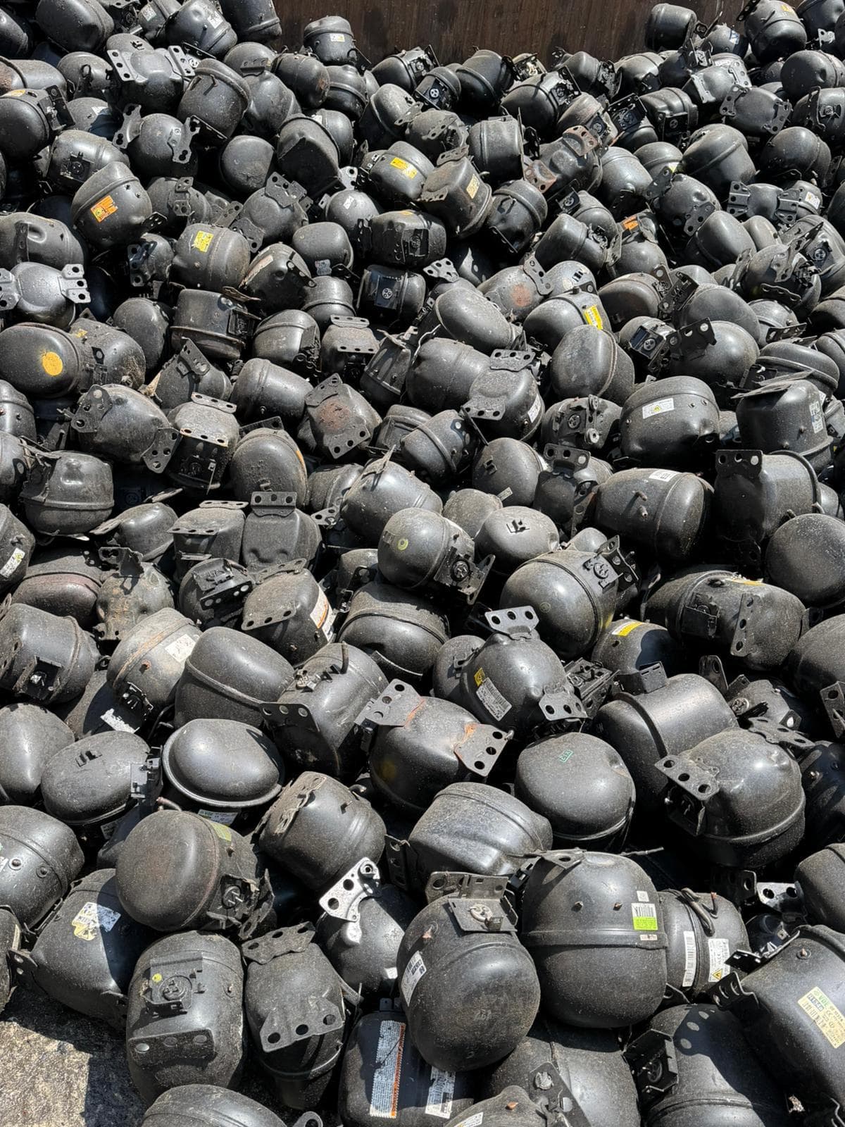 Dense overhead view of sorted compressor scrap at AMT facility
