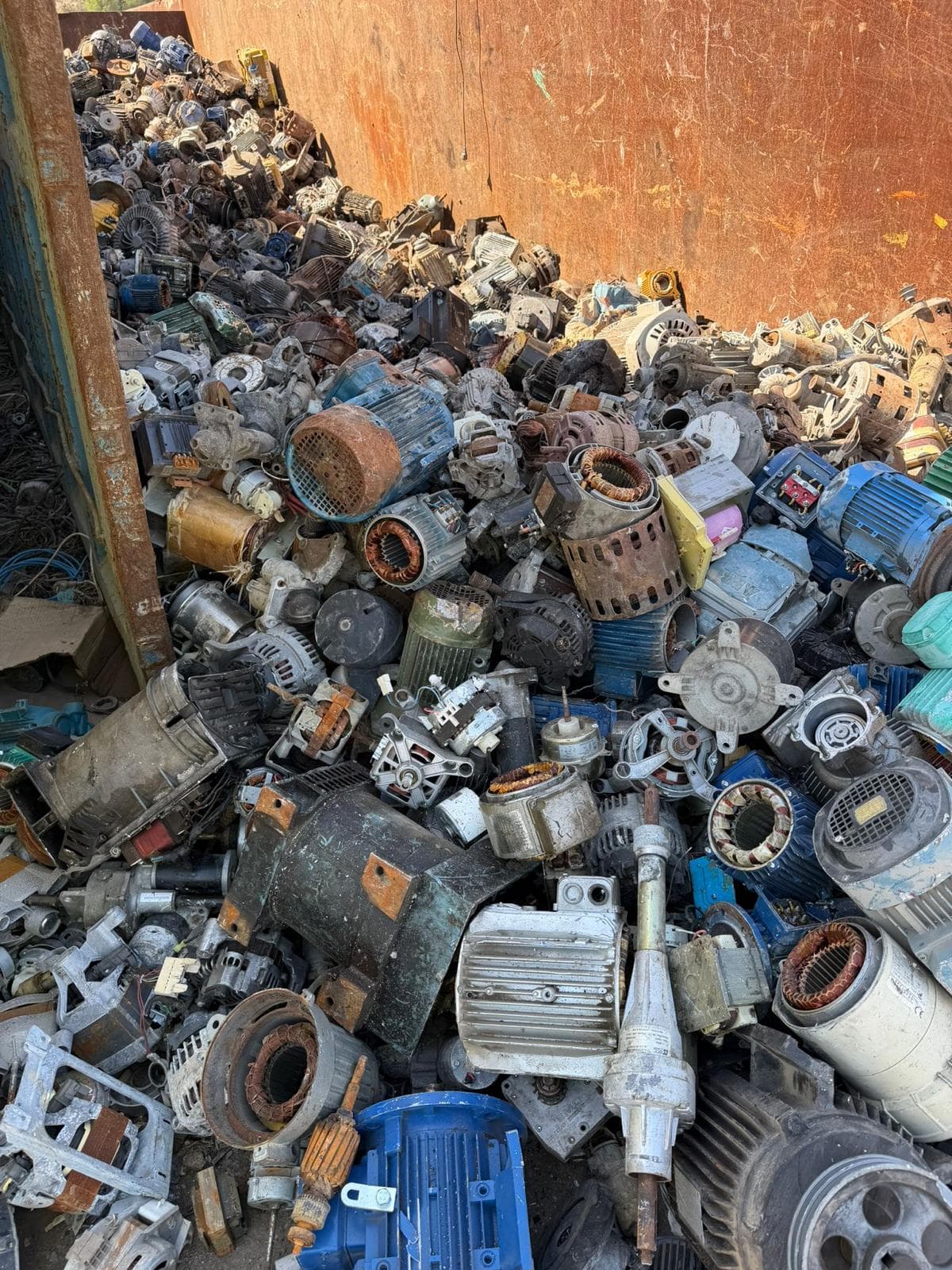 Scrap electric motors and generators in processing container at AMT yard